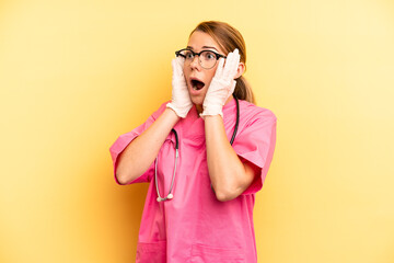 pretty blonde young woman feeling happy, excited and surprised. veterinarian student concept