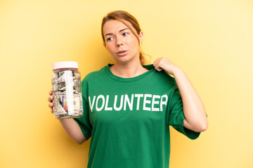 pretty blonde young woman feeling stressed, anxious, tired and frustrated. donation and volunteer...