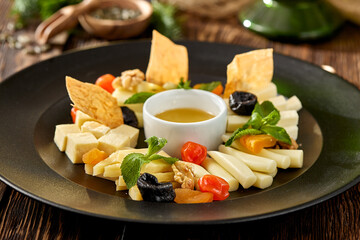 Cheese platter on wooden background in rustic style. Appetizer for wine - georgian cheese with...