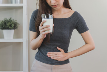 lactose intolerance concept. Woman pushing glass of milk deny to drink.