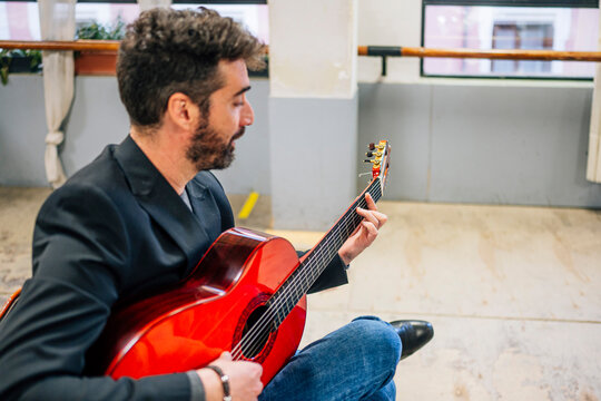 Man Playing Guitar In Music Studio