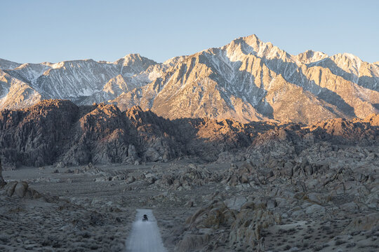 Van driving on road against mountains