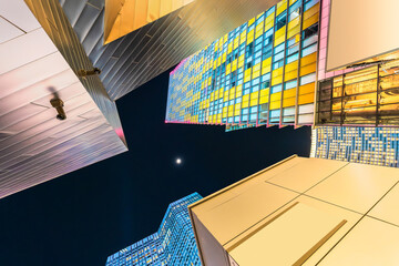 Illuminated Tall Buildings Against Sky At Night