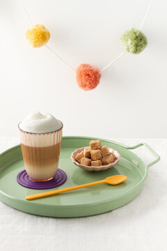 Multilayer Coffee In Glass Cup And Brown Sugar Cubes In Cafe