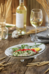 Closeup on gourmet salad with caviar and crab sticks with white wine