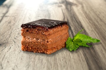 Tasty sweet cake decorated with fresh green mint leaf.Traditional dessert.