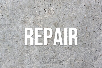 REPAIR - word on concrete background. Cement floor, wall.