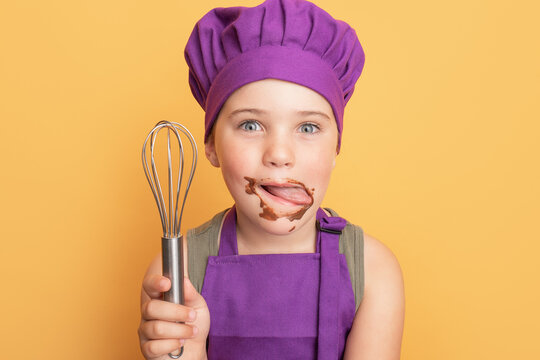 Messy boy licking chocolate off face