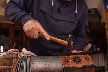 Anonymous artisan making drum shell in workshop