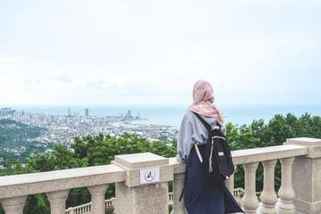 Fototapeta premium Traveler in the mountains, Panorama of the city at the foot of the mountain. Travel in the mountains, holidays in the mountains, hiking