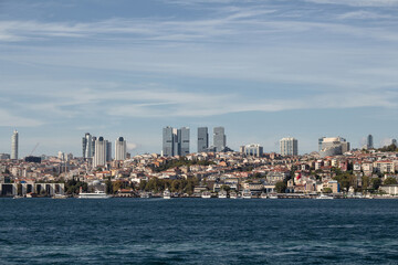 Fototapeta na wymiar View of boats on Bosphorus, Besiktas and Levent districts on European side of Istanbul. It is a sunny summer day.
