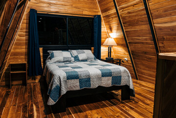 Horizontal of the interior of a cozy room in a log cabin at night. 