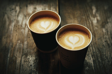 Love date concept. Two coffee cups with a heart latte art.