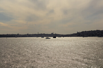 Sunset view of boats on Bosphorus and European side of Istanbul. Beautiful scene.