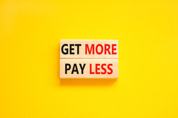 Get more pay less symbol. Concept words Get more pay less on wooden blocks on a beautiful yellow table yellow background. Business Get more pay less concept. Copy space.