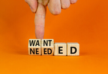 Wanted or needed symbol. Concept words Wanted or needed on wooden cubes. Businessman hand. Beautiful orange table orange background. Business Wanted or needed concept. Copy space.