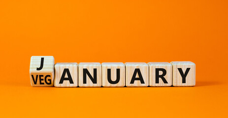 Veganuary in january symbol. Turned wooden cubes and changed the concept word January to Veganuary. Beautiful orange background copy space. Medical and healthy veganuary in january concept.