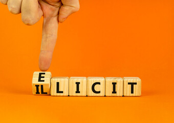 Illicit or elicit symbol. Businessman turns wooden cubes and changes the concept word Illicit to Elicit. Beautiful orange table orange background. Business illicit or elicit concept. Copy space.