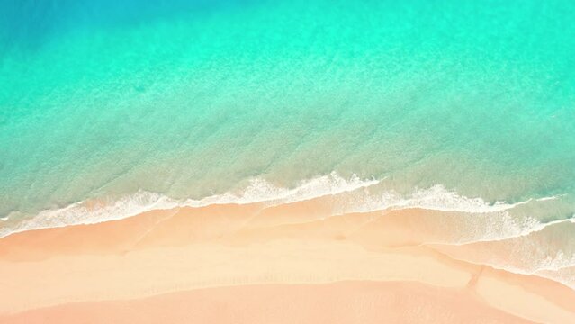 Aerial of beautiful sandy beach washed by azure sea ocean waves. Nobody tropic nature seascape. Abstract paradise summer background. Fuerteventura, Canary Islands, Spain. Water and sand texture