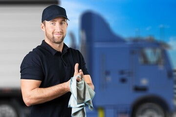 Portrait of confident truck driver on parking outdoor background