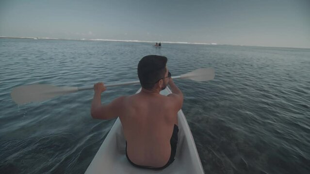 Indonesian Man Canoeing Paddling Canoe at Gunung Payung Beach, Bali, Indonesia Slow Motion