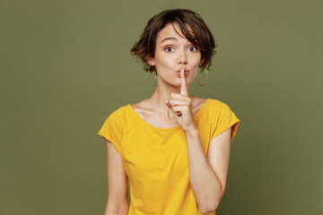Young secret caucasian woman she 20s wear yellow t-shirt say hush be quiet with finger on lips shhh...