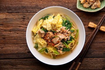 Chinese wonton soup noodle. egg noodles with pork wonton or pork dumplings  Asian food concept...