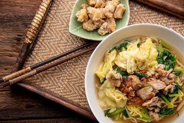 Chinese wonton soup noodle. egg noodles with pork wonton or pork dumplings  Asian food concept style. 