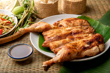 Grilled chicken Thai Food Style on wooden table background. Menu Som Tum Thai - Papaya Salad Concept.