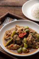 Stir fry spicy catfish on dark wooden background. thaifood concept.