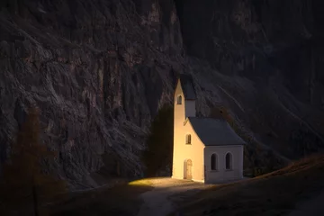 Wall murals Black Incredible view on small iIlluminated chapel - Kapelle Ciapela on Gardena Pass, Italian Dolomites mountains. Dolomite Alps, Italy. Landscape photography