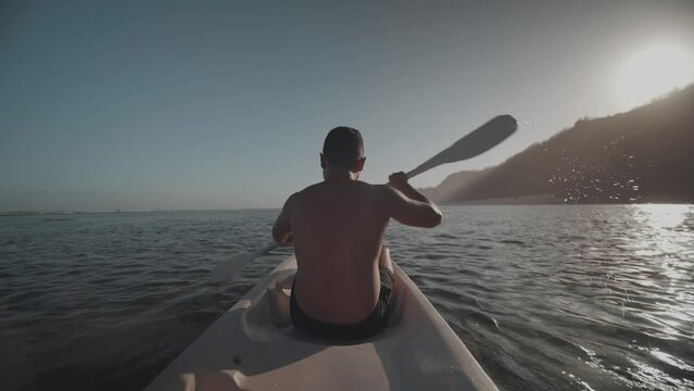 Indonesian Man Canoeing Paddling Canoe at Gunung Payung Beach, Bali, Indonesia Slow Motion