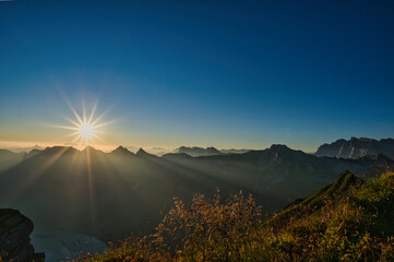 Naklejka na ściany i meble Panorama with sunrise over the Alpstein taken on the Diethelm mountain in the Wägital in Switzerland