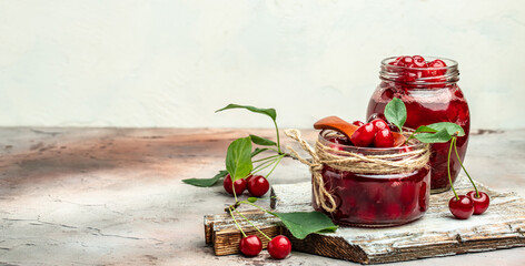 Berries cherry with syrup. Berries cherry with syrup. Canned fruit on a light background. Long banner format
