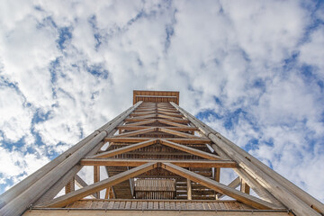 Vertical image of Goethe Tower structure in Frankfurt against blue sky