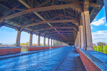Walk along the covered Ponte Coperto bridge in Pavia city, Italy