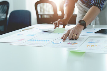 businessman hands using a calculator to check company finances and earnings and budget. calculating monthly expenses, managing budget, papers, loan documents, invoices concepts