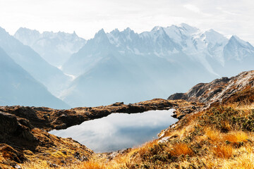 Colourful sunset on Chesery lake (Lac De Cheserys) in France Alps. Monte Bianco mountain range on...