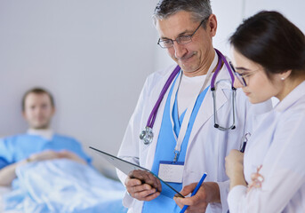 A medical team of doctors, man and woman,standing in hospital