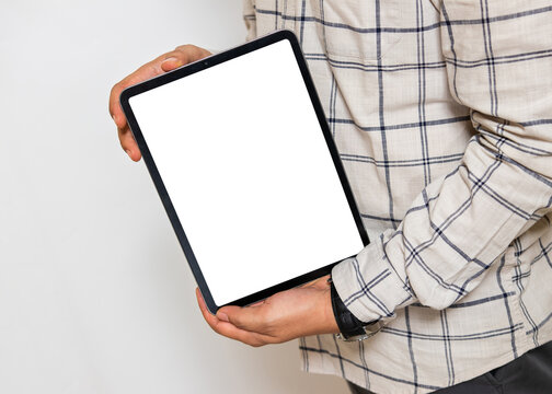 Mockup image of a man holding a white blank screen tablet
