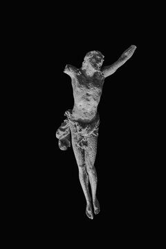 Very ancient destroyed iron statue of crucifixion of Jesus Christ. Black and white image.