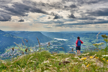 nice senior woman hiking at Mount Gruenten in the Allgaeu Alps with awesomw view over Iller valley...
