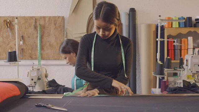 Latin women making clothes in an artisan workshop.
