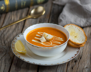 tomato soup with garlic bread served in a bowl isolated on wooden background side view of soup