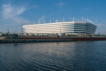 Football stadium for World Cup matches on the bank of the Pregolya River on a sunny summer day,...