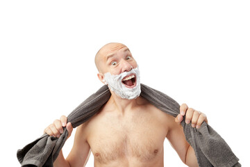 Bald man saving beard with shave foam over face holding razor scared and amazed with open mouth for...