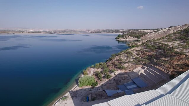 Aerial view Zeugma archeological excavation site, Birecik dam and water reservoir on Euphrates river. Belkis, Gaziantep province, Turkiye