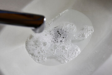 They wash their hands in the sink, the sewer pipe of which is clogged.