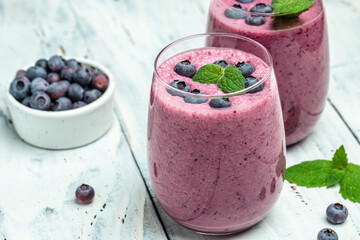 blueberry smoothie in glass on a light background. fruit dessert, healthy dieting concept Natural detox