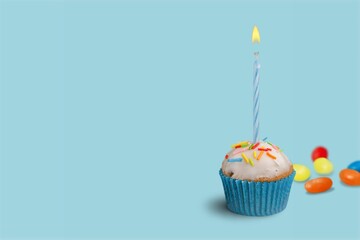 Celebration birthday cupcake on color background